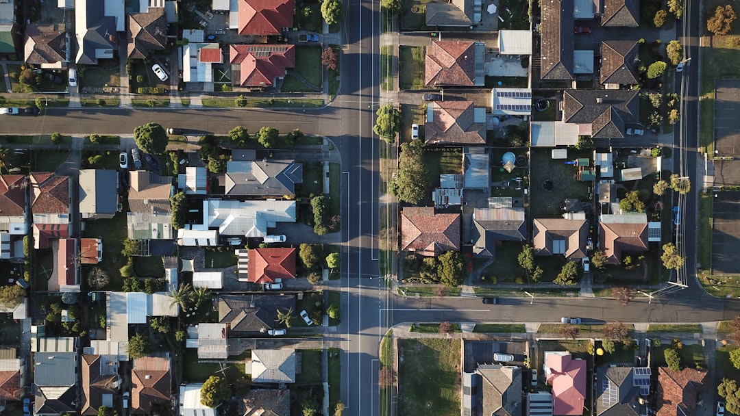 Aerial view of a residential neighborhood with rows of houses and streets.