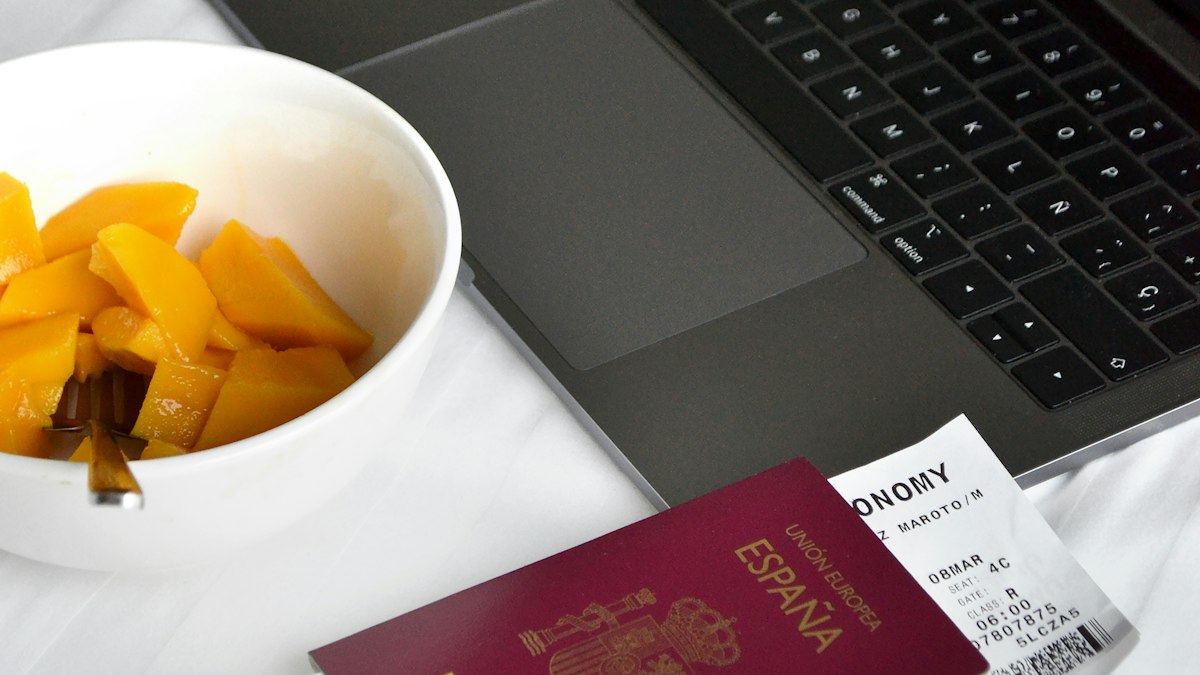 Passport, boarding pass and laptop prepared for an international move