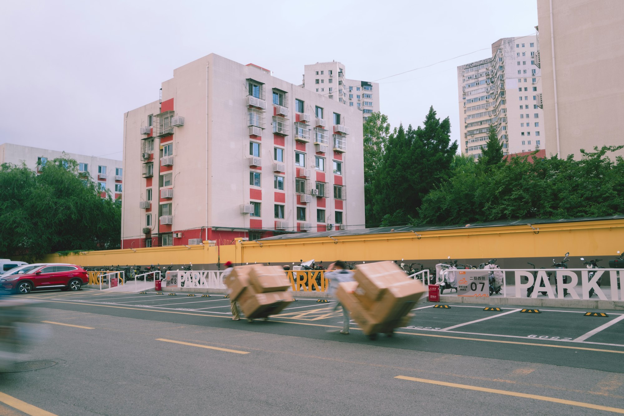Cardboard moving boxes being transported past apartment buildings during a move