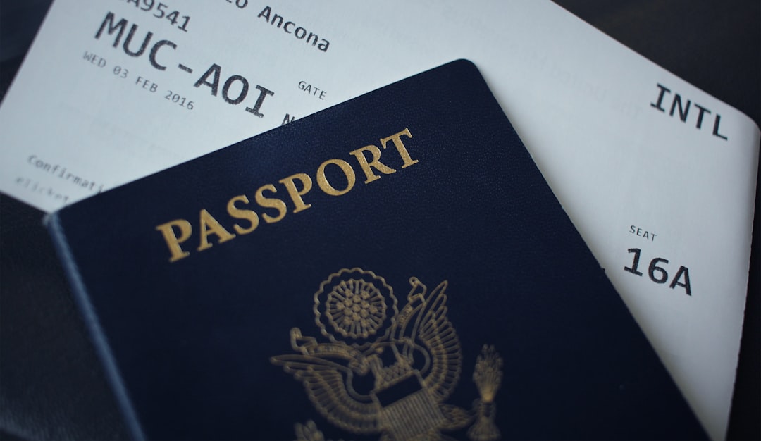 Passport and travel documents on a table before an international border crossing.